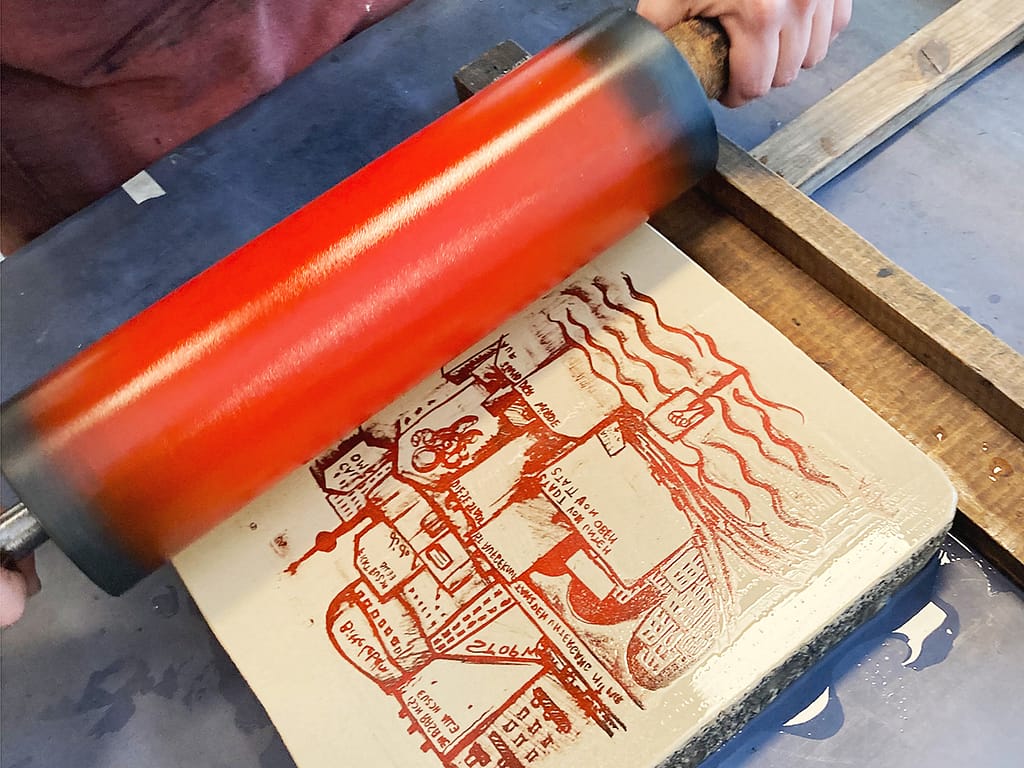 Rolling ink on a lithographic stone