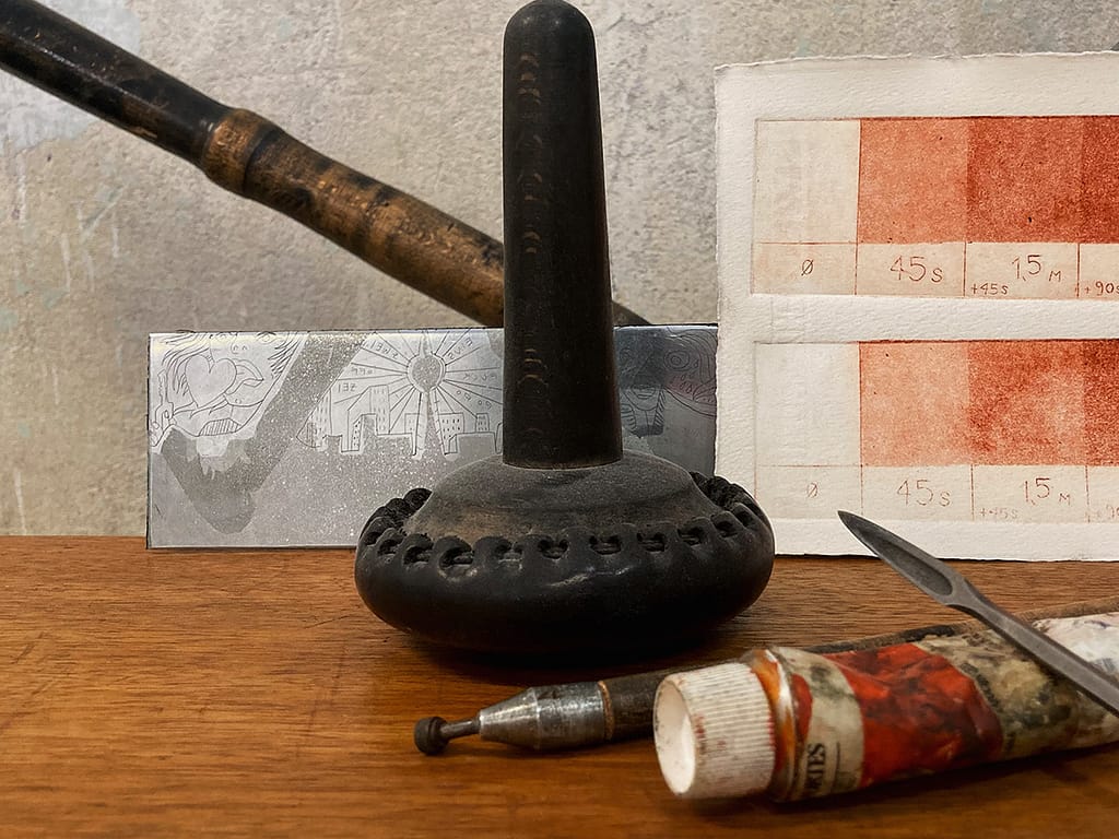 Tools and material for etching: aquatint scale, paint, needle, tampon and zinc plate