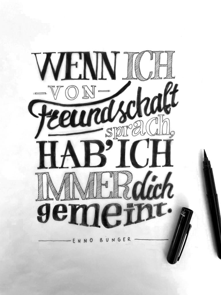 Lettering design on tracing paper with writing tool next to it. Text states »When I spoke of friendship, I always meant you" by Enno Bunger.
